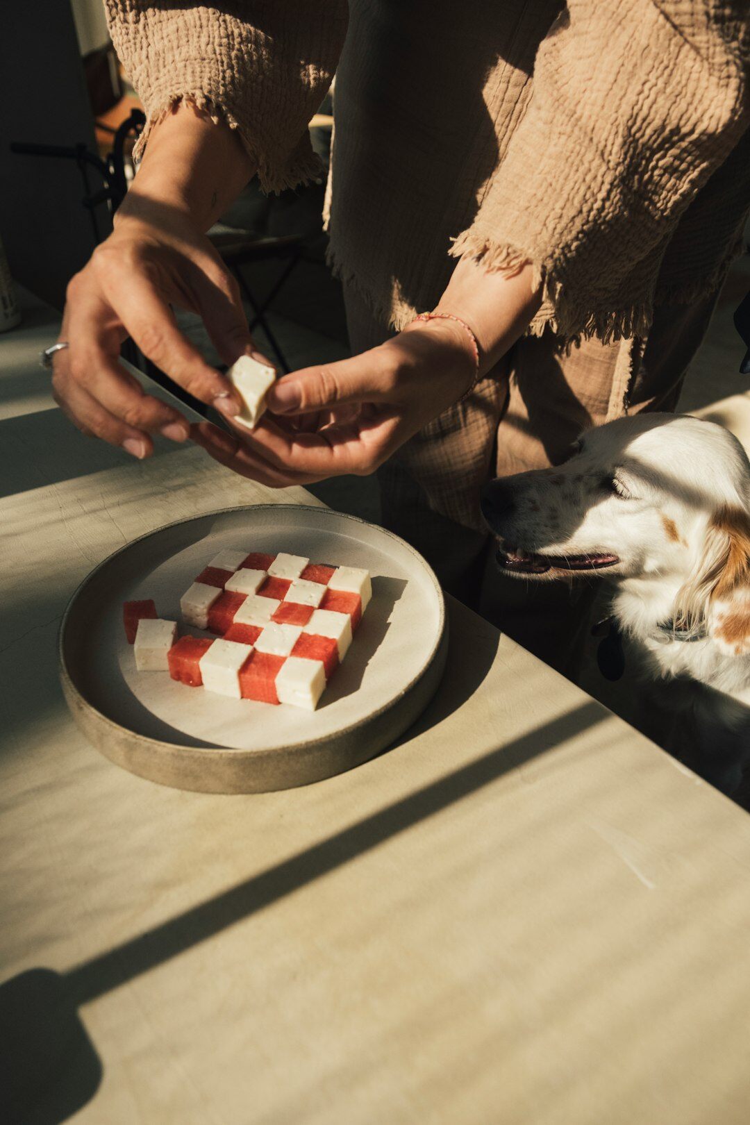Hands sorting through printed photographs on a light table